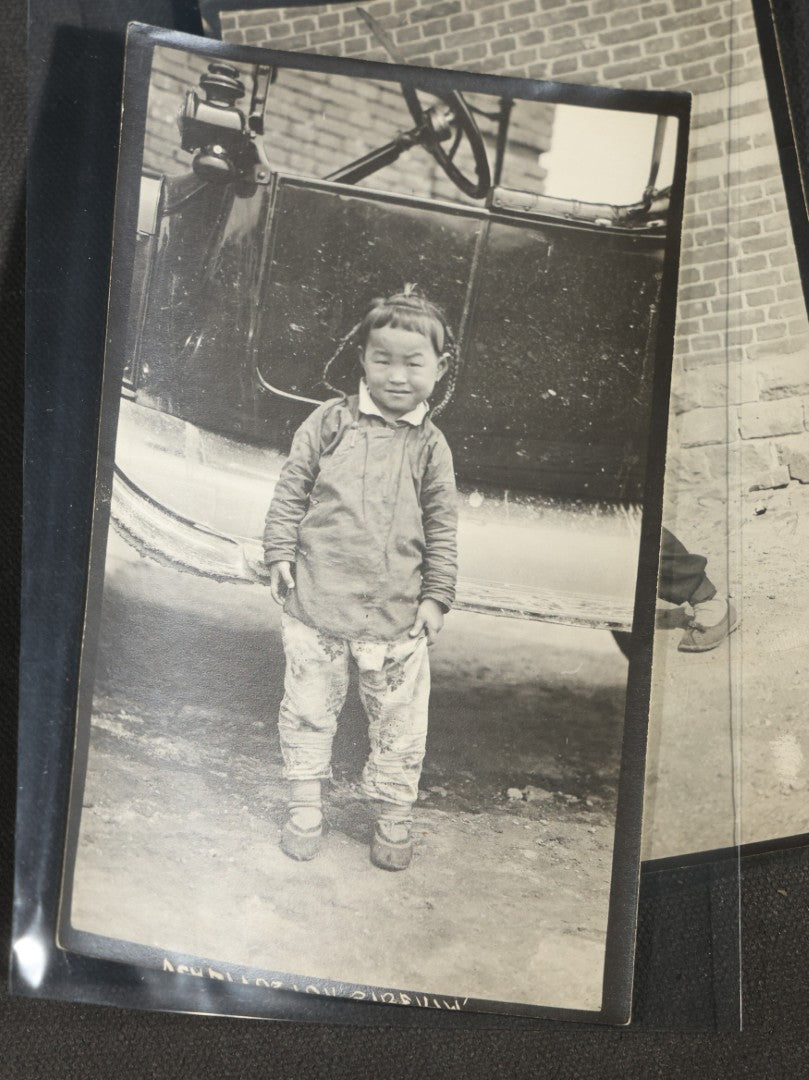 Grouping of 12 Antique Snapshot Photographs, East Asian and Russian-Language Settings including Sword Performer, Street Performer with Knife, Man with Trained Bear, Fishermen with Crabs, Construction Workers, and Children