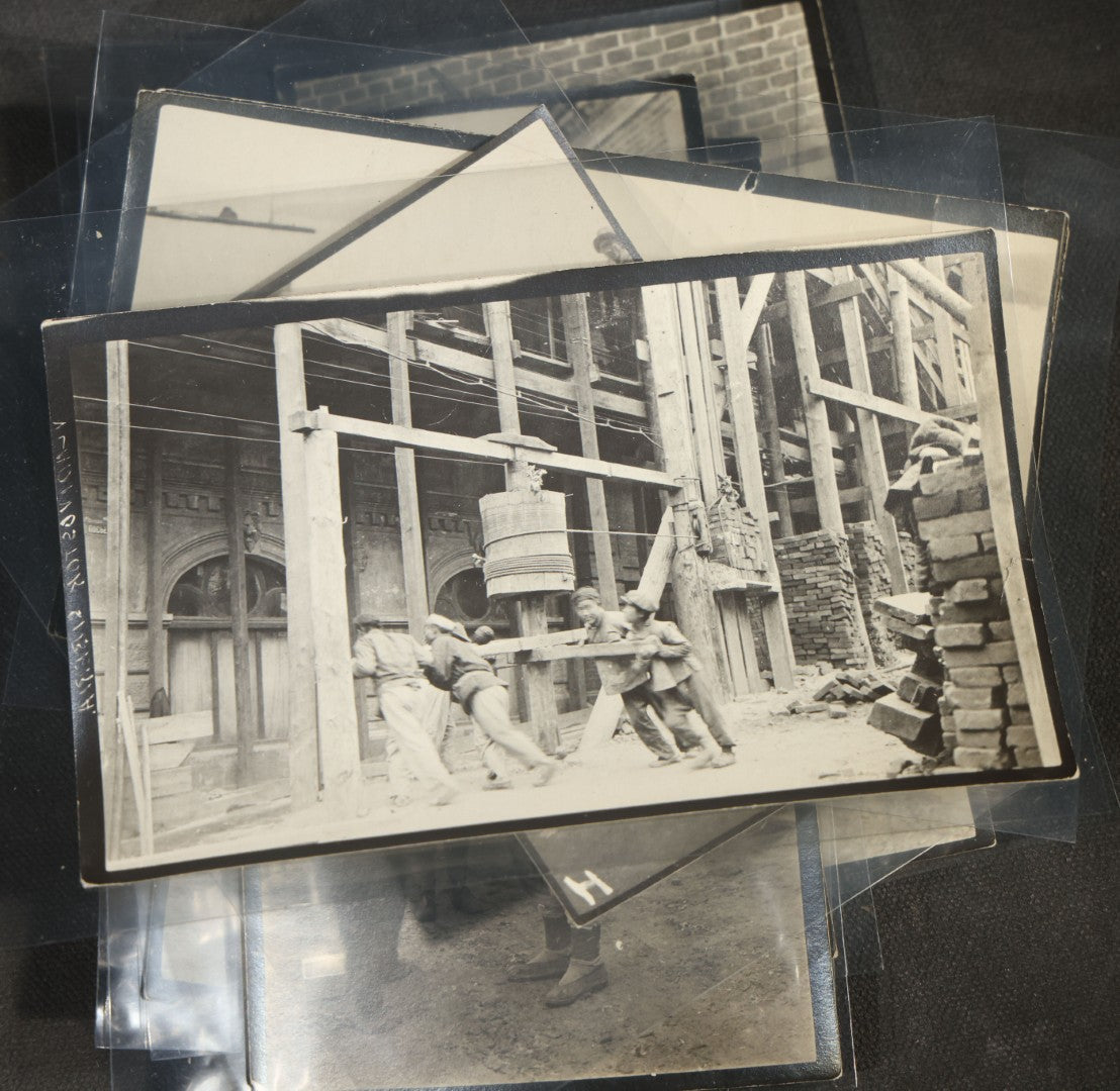 Grouping of 12 Antique Snapshot Photographs, East Asian and Russian-Language Settings including Sword Performer, Street Performer with Knife, Man with Trained Bear, Fishermen with Crabs, Construction Workers, and Children