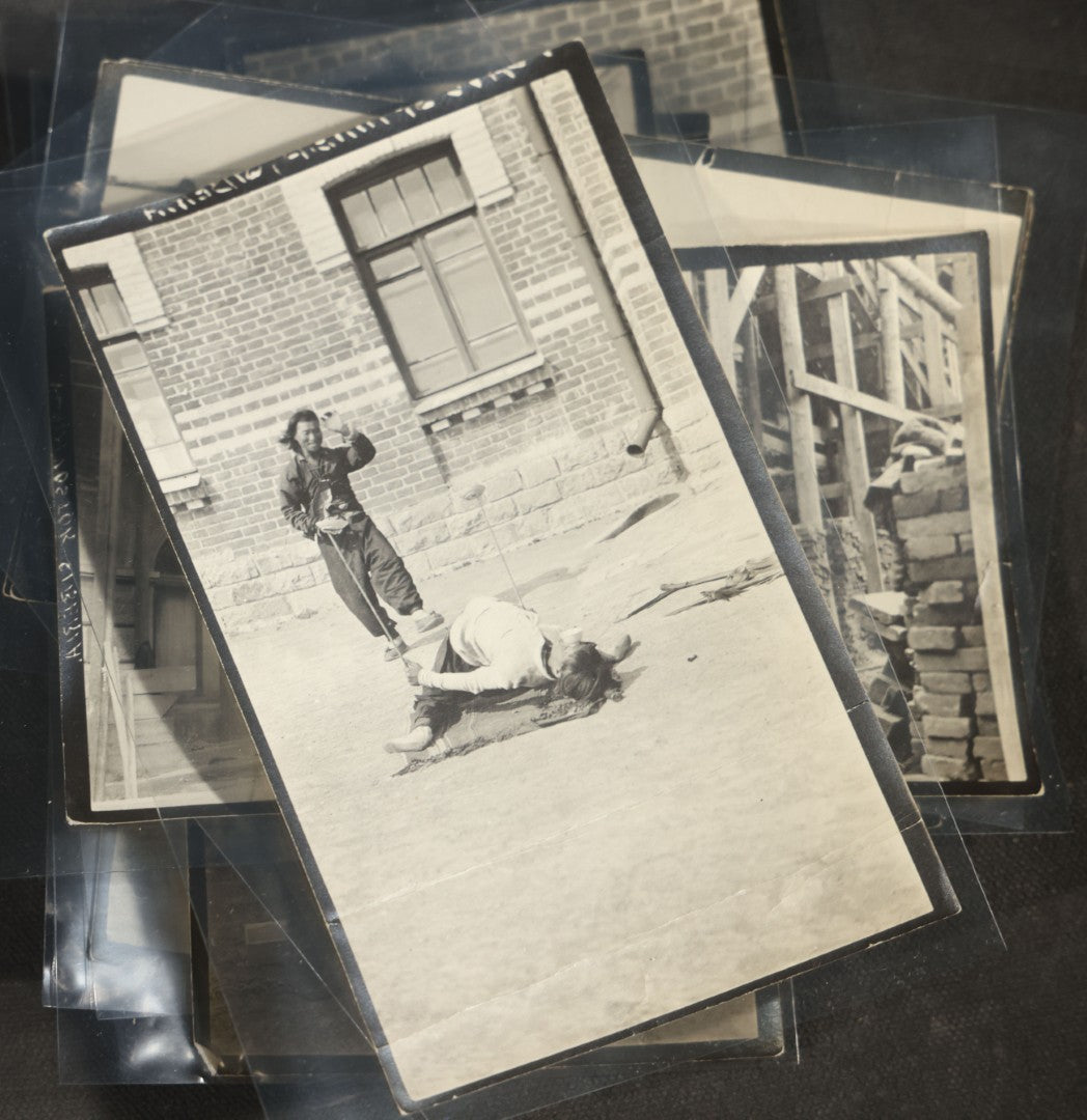Grouping of 12 Antique Snapshot Photographs, East Asian and Russian-Language Settings including Sword Performer, Street Performer with Knife, Man with Trained Bear, Fishermen with Crabs, Construction Workers, and Children