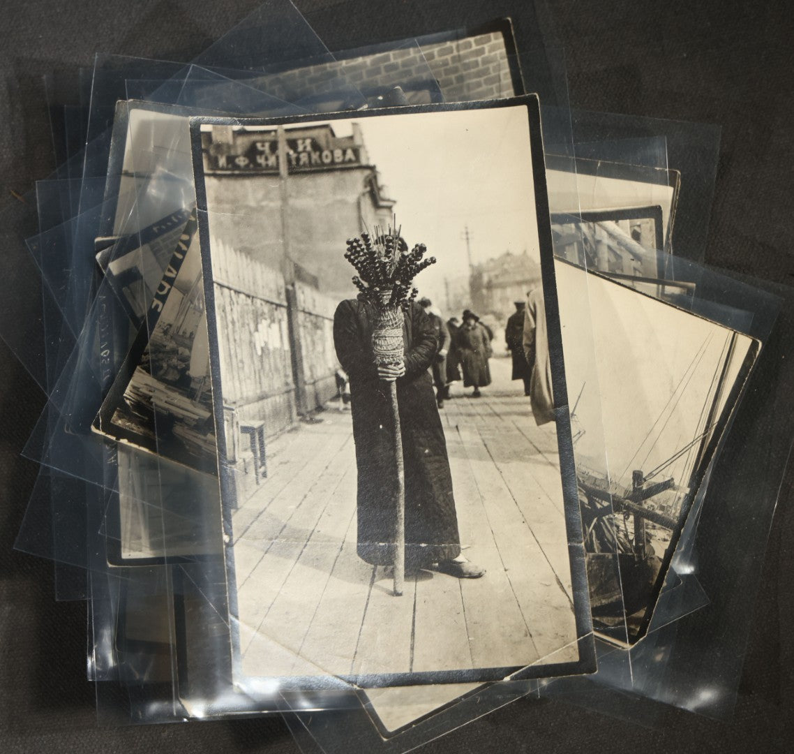 Grouping of 12 Antique Snapshot Photographs, East Asian and Russian-Language Settings including Sword Performer, Street Performer with Knife, Man with Trained Bear, Fishermen with Crabs, Construction Workers, and Children