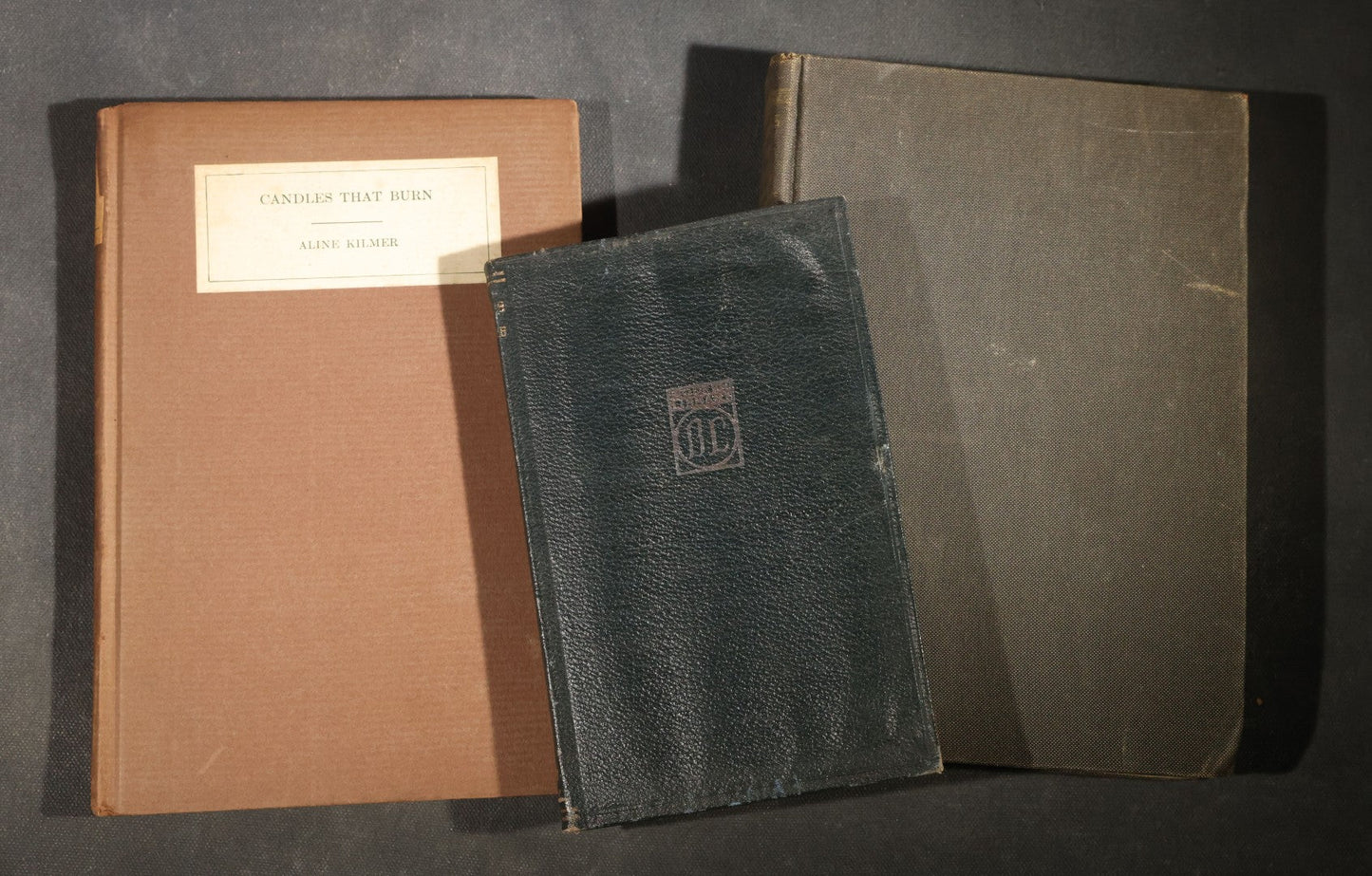 Trio of Antique and Vintage Poetry and Literature Books including "Candide" by Voltaire, "Candles That Burn" by Aline Kilmer, and "Flowers of Evil" by Charles Baudelaire