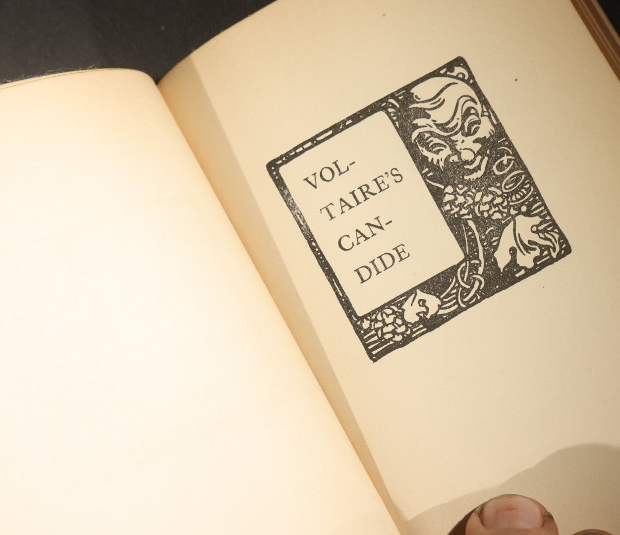 Trio of Antique and Vintage Poetry and Literature Books including "Candide" by Voltaire, "Candles That Burn" by Aline Kilmer, and "Flowers of Evil" by Charles Baudelaire