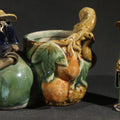 Lot 110 - Pair of Vintage Chinese Mudman Ceramic Figurines Including Seated Figure on Melon Planter and Standing Elder in Green Robe, Made in China