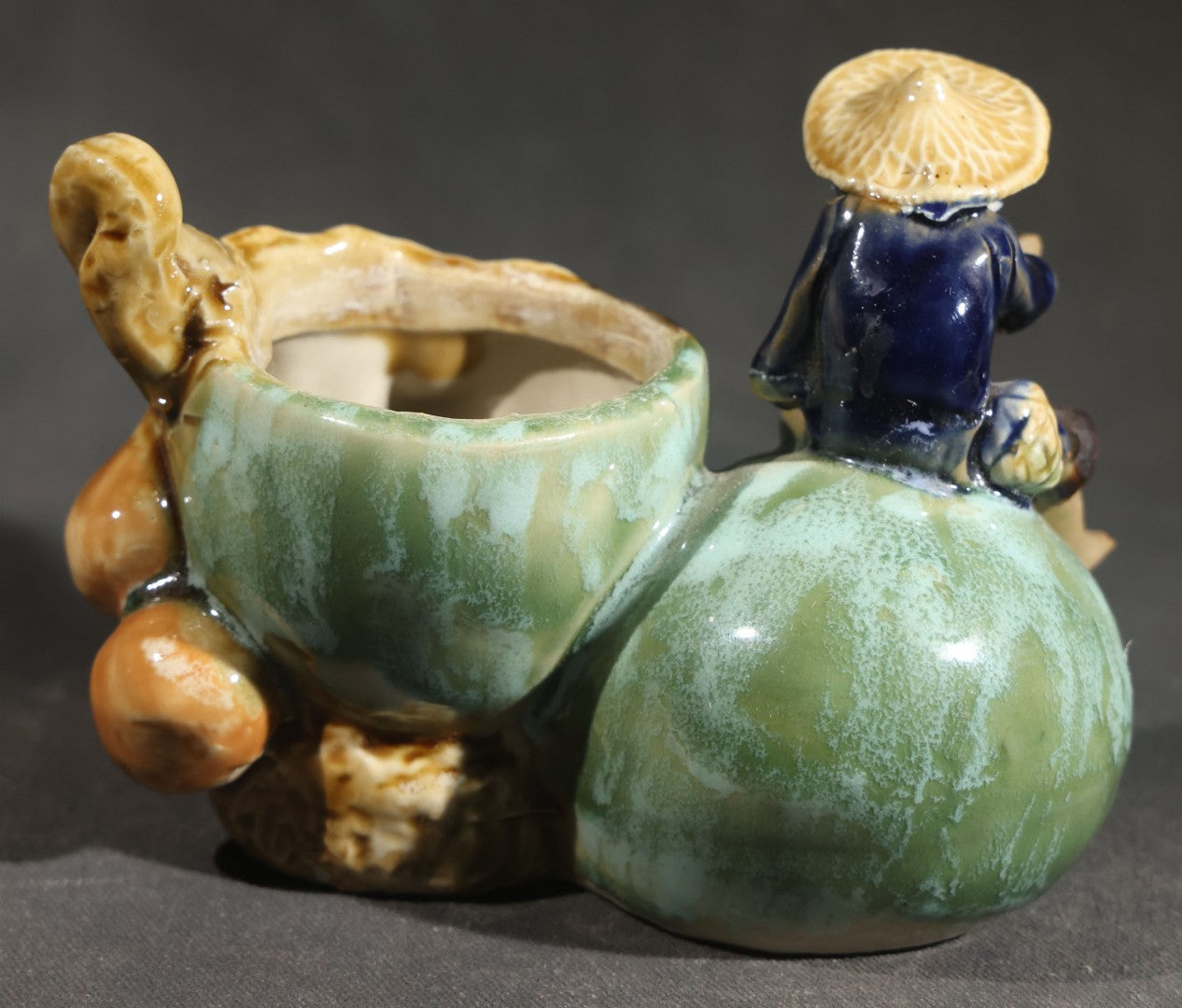 Pair of Vintage Chinese Mudman Ceramic Figurines including Seated Figure on Melon Planter and Standing Elder in Green Robe, Made in China