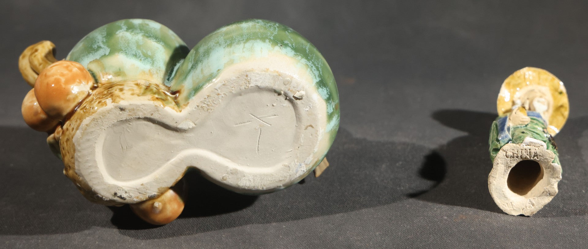 Pair of Vintage Chinese Mudman Ceramic Figurines including Seated Figure on Melon Planter and Standing Elder in Green Robe, Made in China