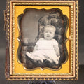 Lot 174 - Antique 1/6th Plate Daguerreotype Photograph of a Seated Baby in White Gown in Half Leatherette Case with Embossed Floral Design