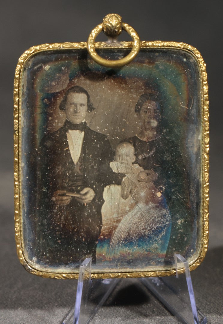 Antique 1/9th Plate Daguerreotype Photograph of a Family, Man, Woman, and Child, in Brass Hanging Frame with Embossed Floral Border and Ring Loop