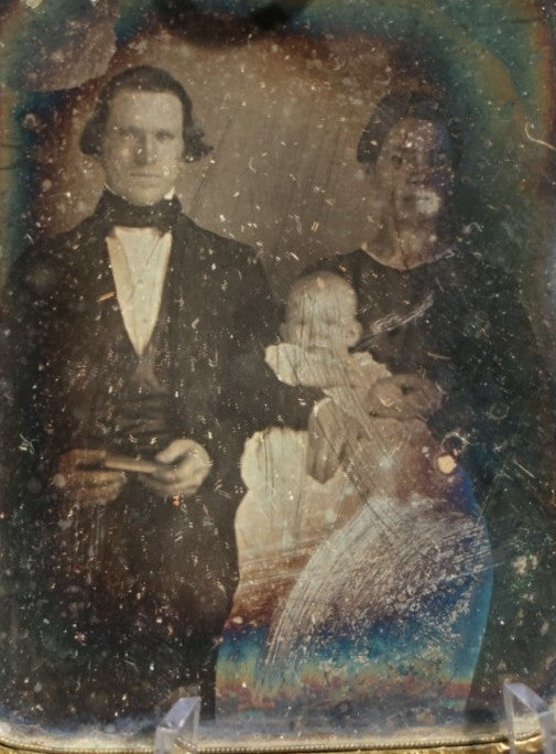 Antique 1/9th Plate Daguerreotype Photograph of a Family, Man, Woman, and Child, in Brass Hanging Frame with Embossed Floral Border and Ring Loop