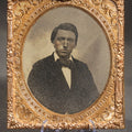 Lot 180 - Antique 1/9th Plate Tintype Photograph of a Young Man in Suit and Bow Tie, Uncased with Brass Mat and Preserver