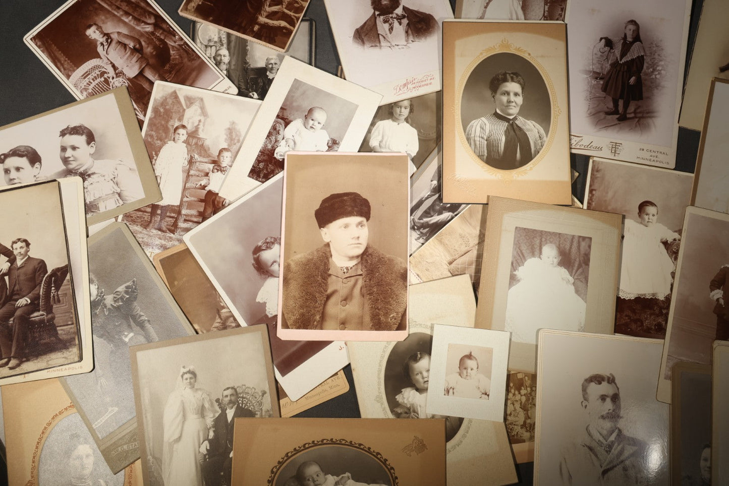 Grouping of 35+ Antique Cabinet Card and Board-Mounted Photographs including Schoolroom Interior and Posed Couple in Fur Coats