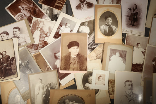 Grouping of 35+ Antique Cabinet Card and Board-Mounted Photographs including Schoolroom Interior and Posed Couple in Fur Coats