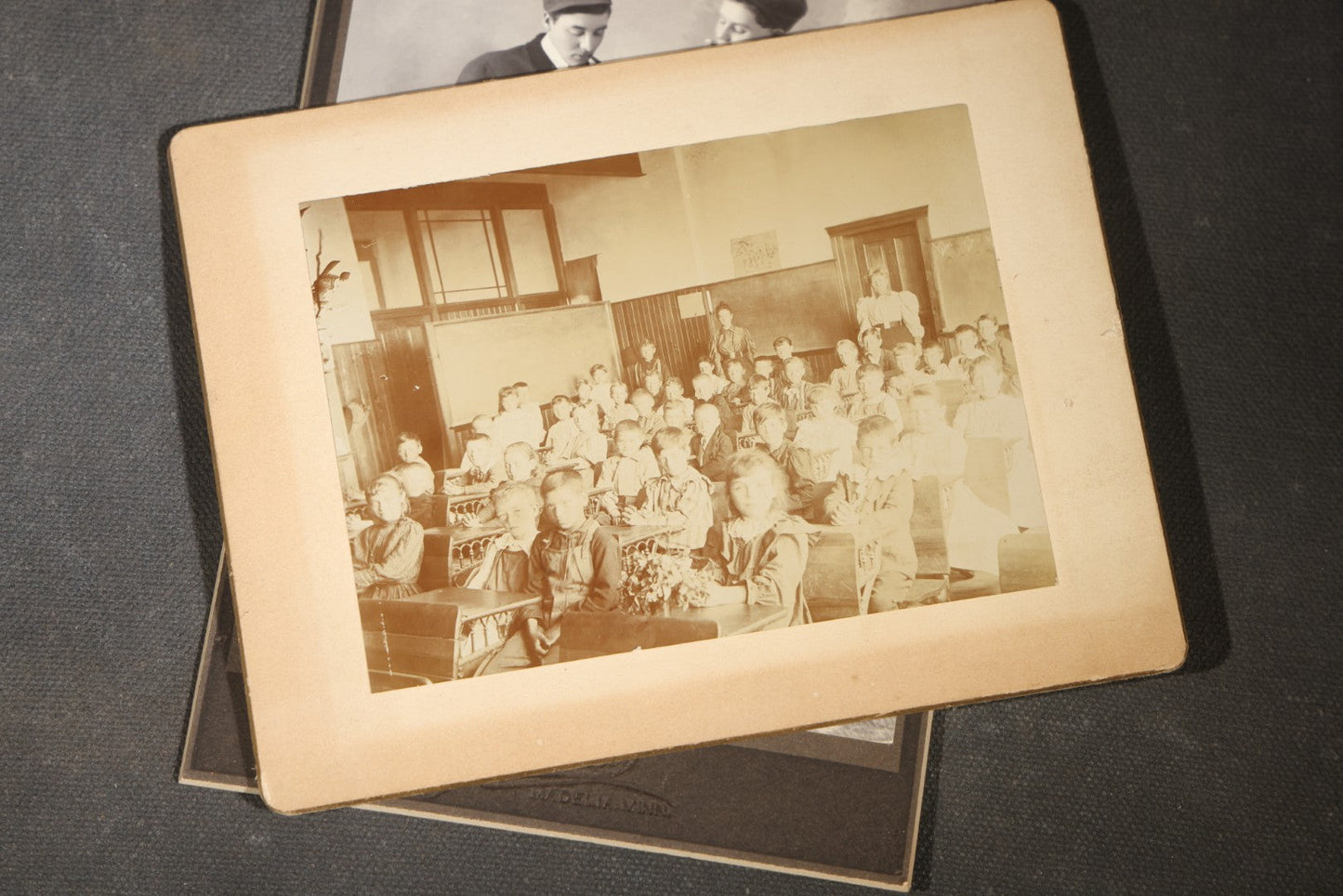 Grouping of 35+ Antique Cabinet Card and Board-Mounted Photographs including Schoolroom Interior and Posed Couple in Fur Coats