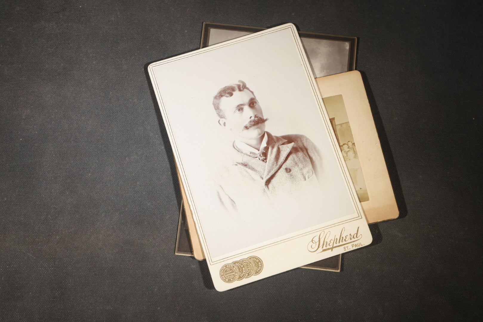 Grouping of 35+ Antique Cabinet Card and Board-Mounted Photographs including Schoolroom Interior and Posed Couple in Fur Coats