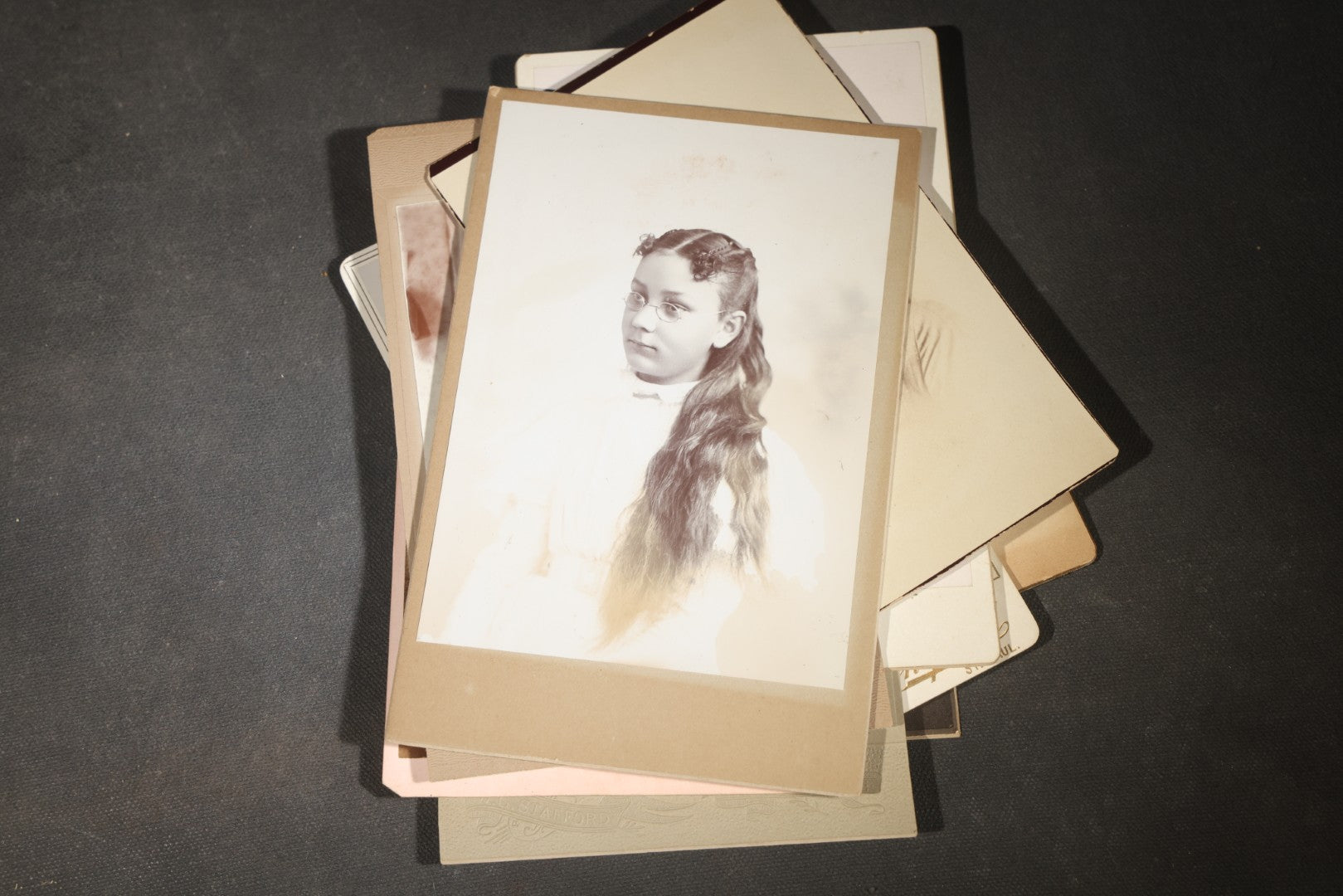 Grouping of 35+ Antique Cabinet Card and Board-Mounted Photographs including Schoolroom Interior and Posed Couple in Fur Coats