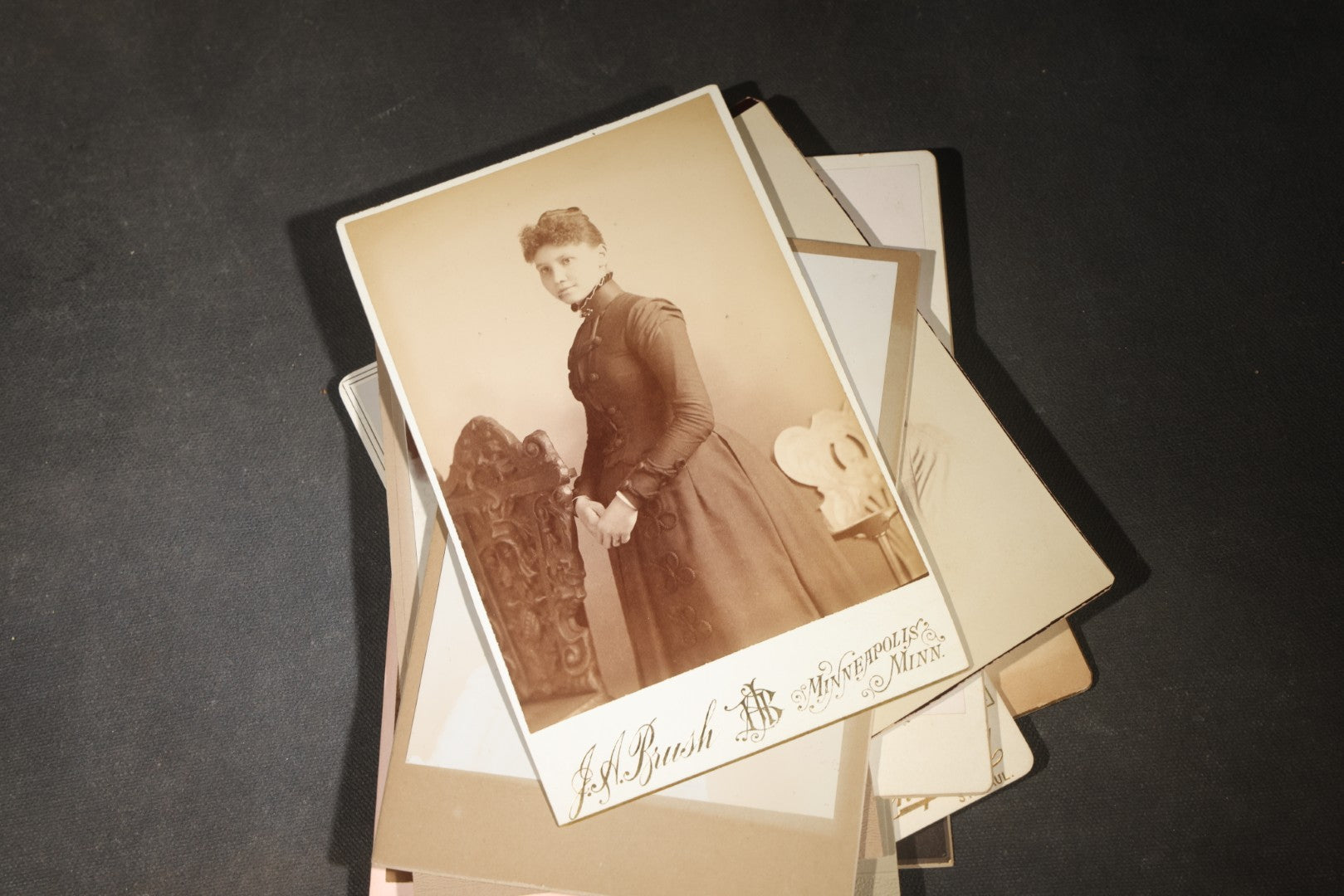 Grouping of 35+ Antique Cabinet Card and Board-Mounted Photographs including Schoolroom Interior and Posed Couple in Fur Coats