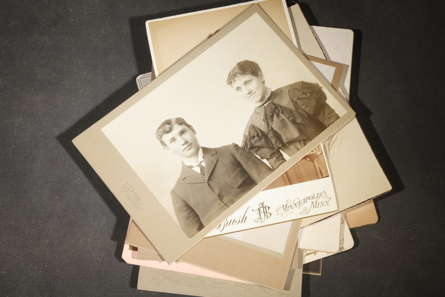 Grouping of 35+ Antique Cabinet Card and Board-Mounted Photographs including Schoolroom Interior and Posed Couple in Fur Coats