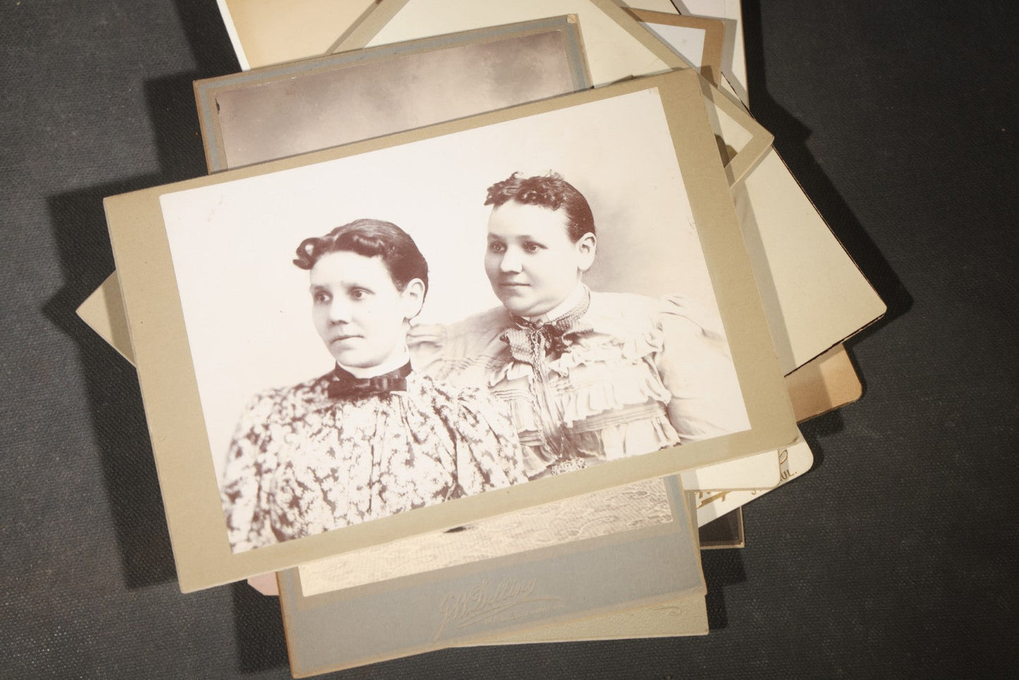 Grouping of 35+ Antique Cabinet Card and Board-Mounted Photographs including Schoolroom Interior and Posed Couple in Fur Coats