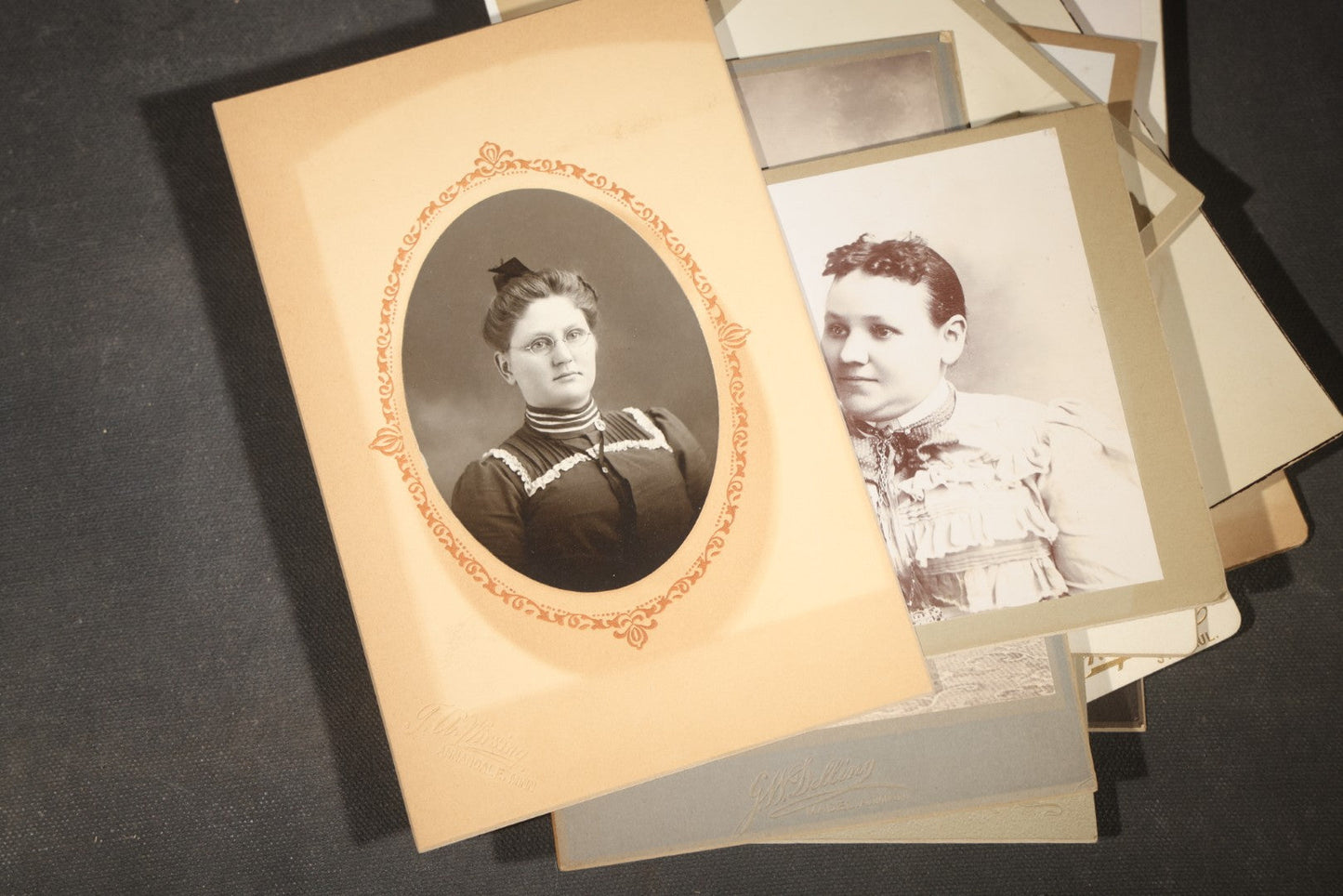 Grouping of 35+ Antique Cabinet Card and Board-Mounted Photographs including Schoolroom Interior and Posed Couple in Fur Coats
