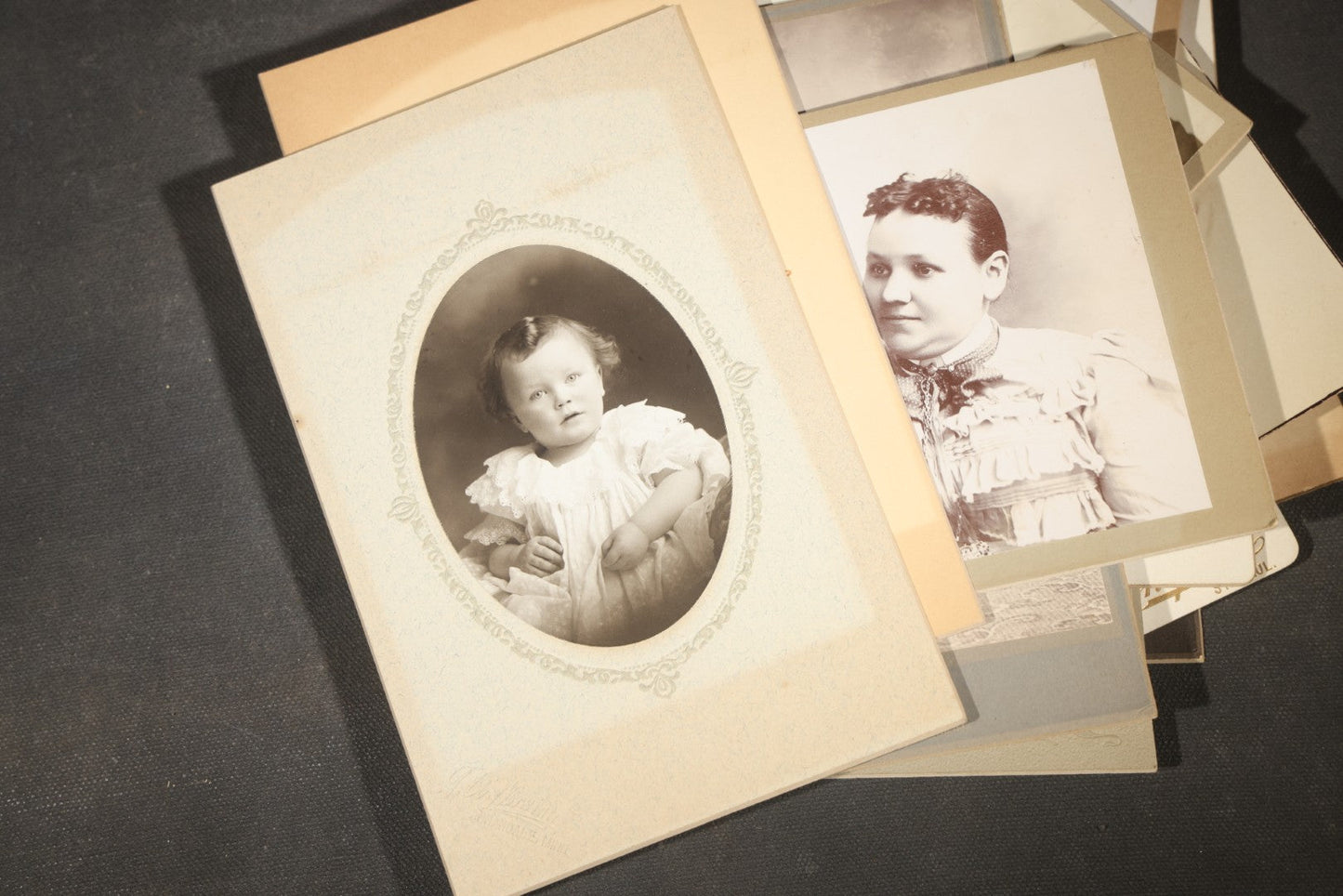 Grouping of 35+ Antique Cabinet Card and Board-Mounted Photographs including Schoolroom Interior and Posed Couple in Fur Coats
