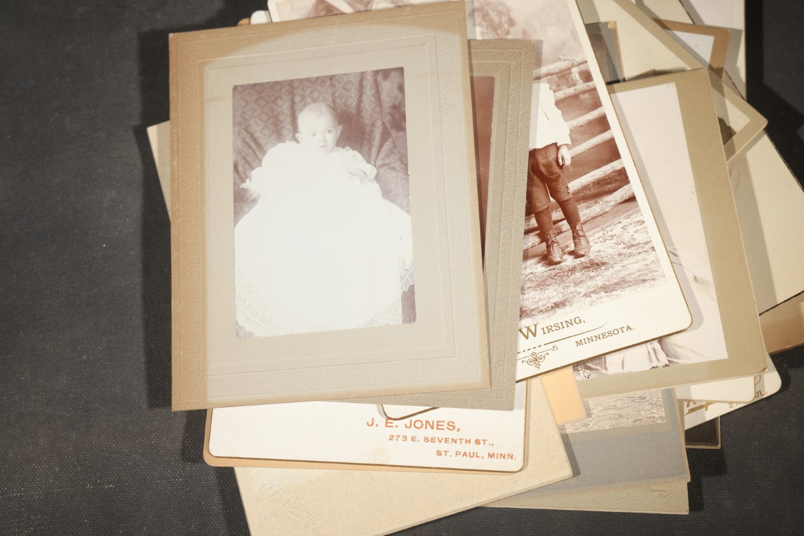 Grouping of 35+ Antique Cabinet Card and Board-Mounted Photographs including Schoolroom Interior and Posed Couple in Fur Coats