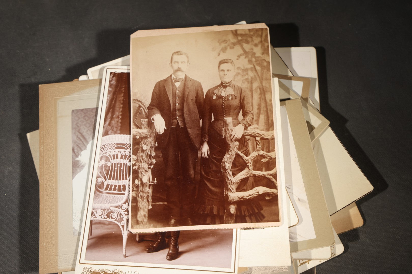 Grouping of 35+ Antique Cabinet Card and Board-Mounted Photographs including Schoolroom Interior and Posed Couple in Fur Coats