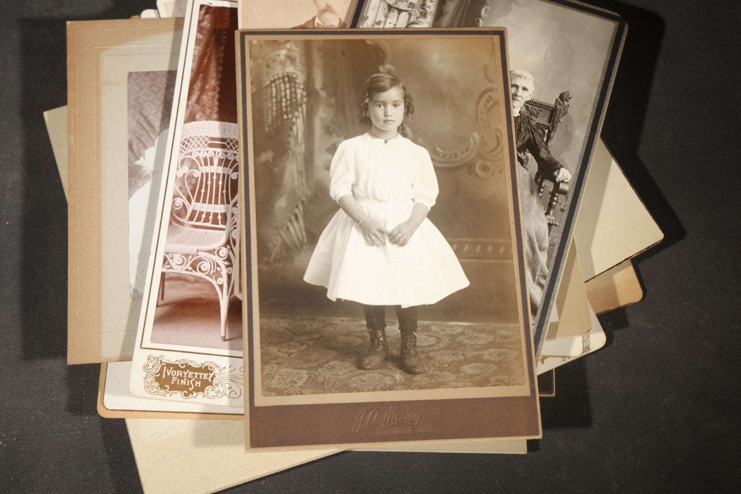 Grouping of 35+ Antique Cabinet Card and Board-Mounted Photographs including Schoolroom Interior and Posed Couple in Fur Coats