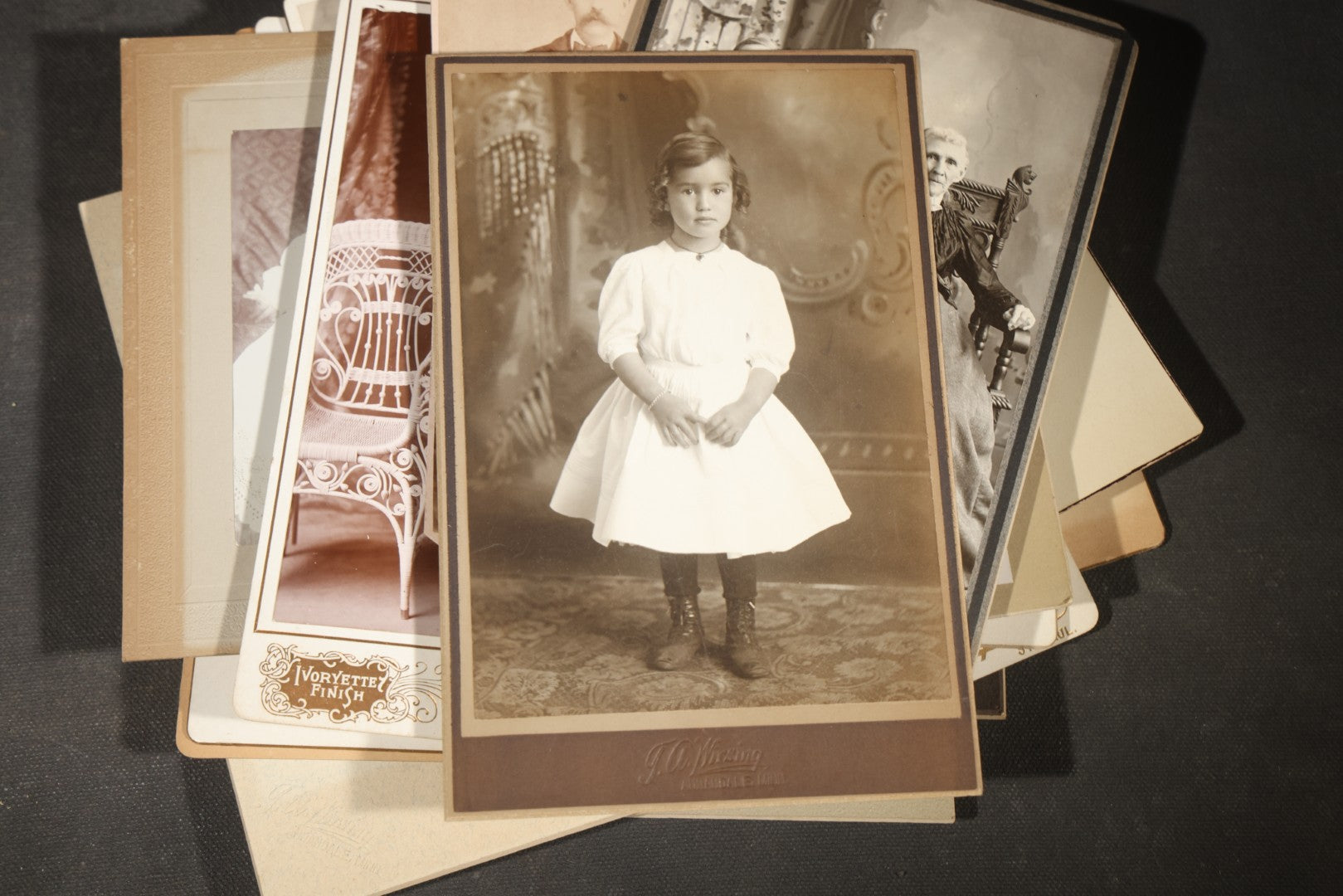 Grouping of 35+ Antique Cabinet Card and Board-Mounted Photographs including Schoolroom Interior and Posed Couple in Fur Coats