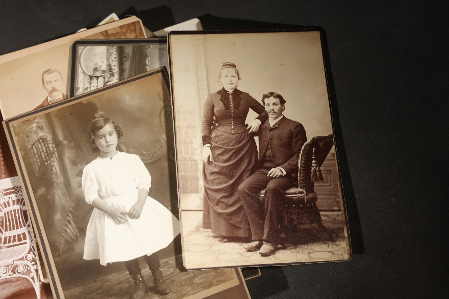 Grouping of 35+ Antique Cabinet Card and Board-Mounted Photographs including Schoolroom Interior and Posed Couple in Fur Coats