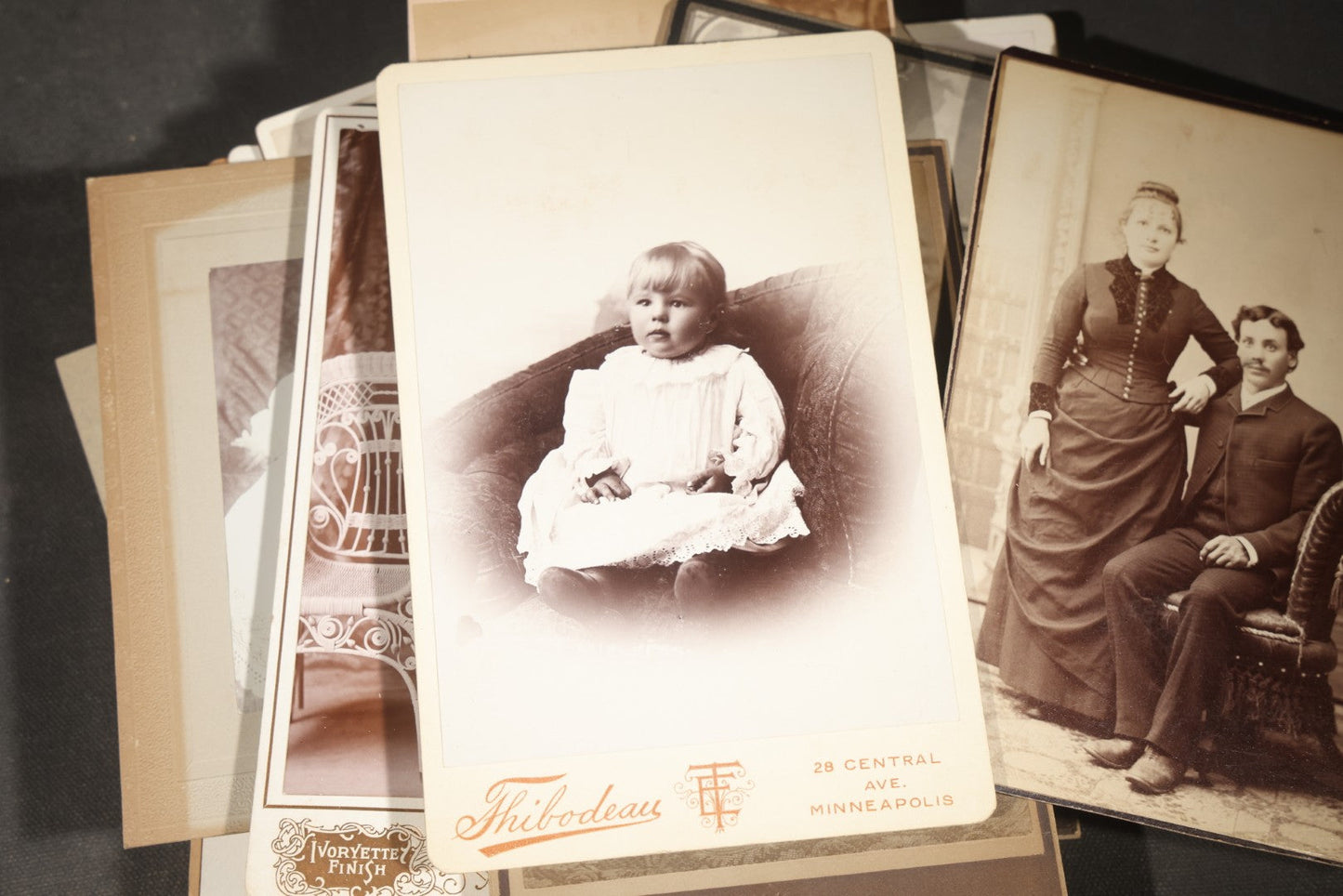 Grouping of 35+ Antique Cabinet Card and Board-Mounted Photographs including Schoolroom Interior and Posed Couple in Fur Coats