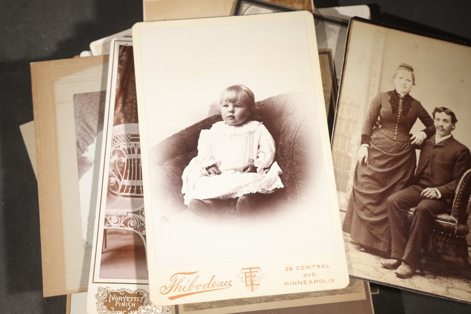 Grouping of 35+ Antique Cabinet Card and Board-Mounted Photographs including Schoolroom Interior and Posed Couple in Fur Coats