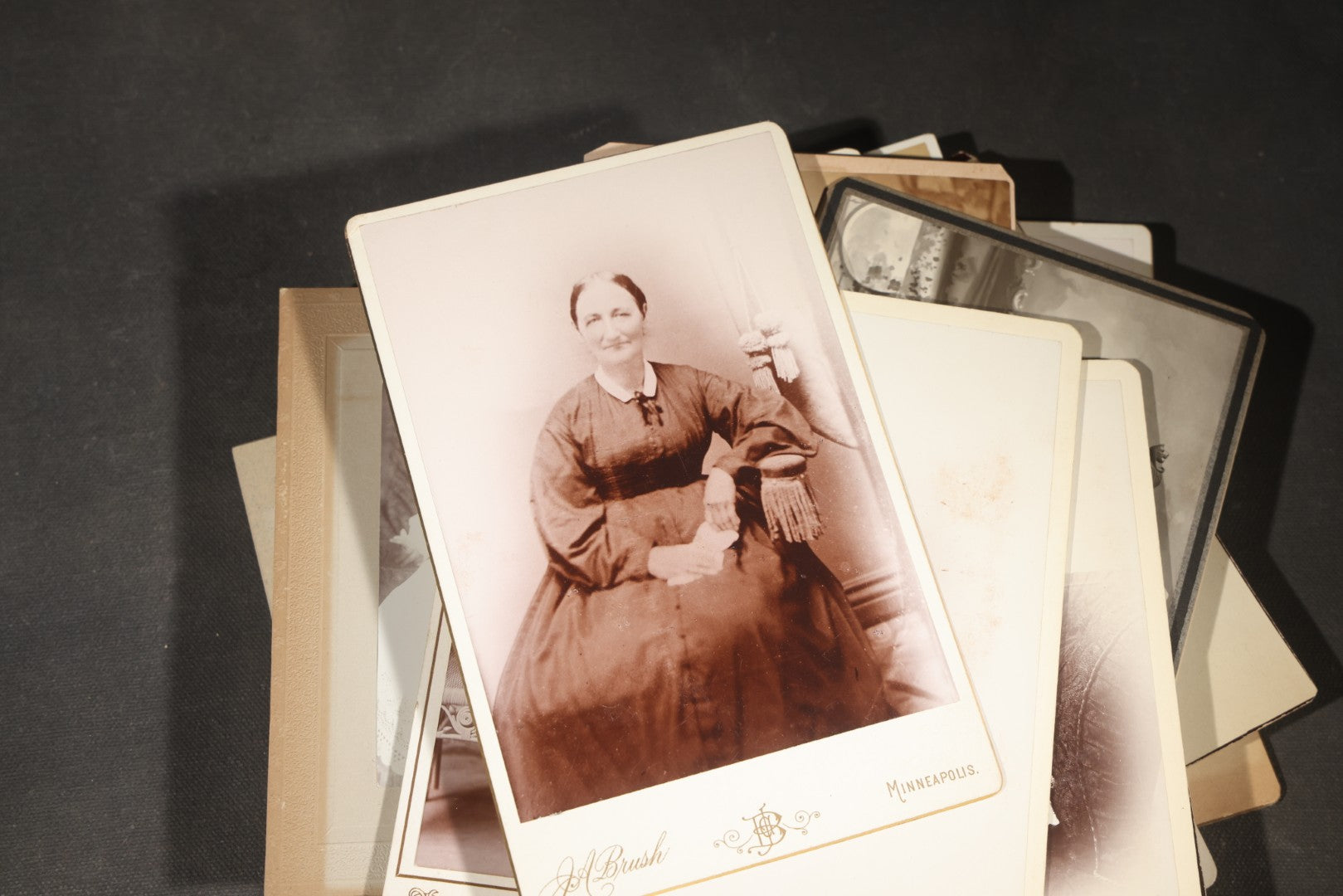 Grouping of 35+ Antique Cabinet Card and Board-Mounted Photographs including Schoolroom Interior and Posed Couple in Fur Coats