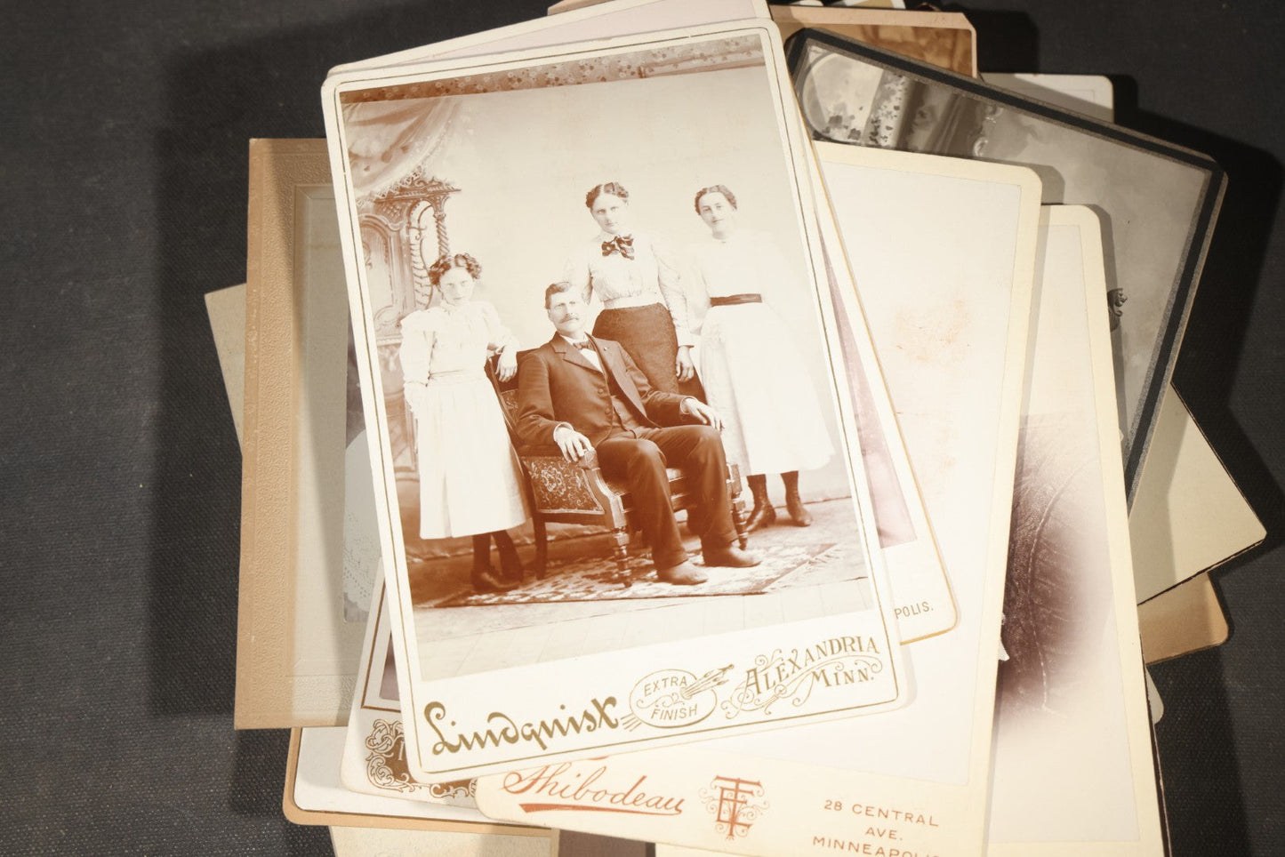 Grouping of 35+ Antique Cabinet Card and Board-Mounted Photographs including Schoolroom Interior and Posed Couple in Fur Coats