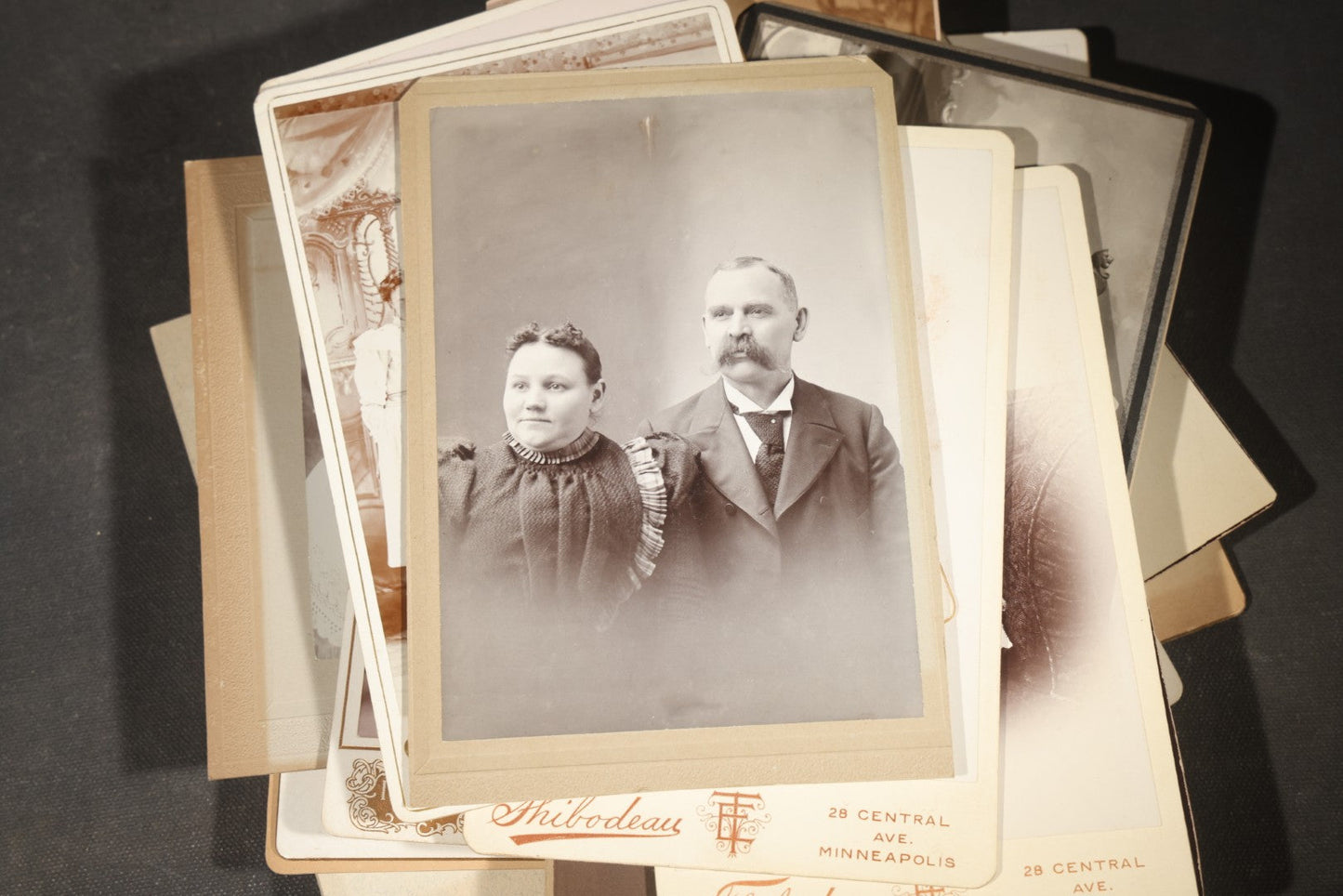 Grouping of 35+ Antique Cabinet Card and Board-Mounted Photographs including Schoolroom Interior and Posed Couple in Fur Coats