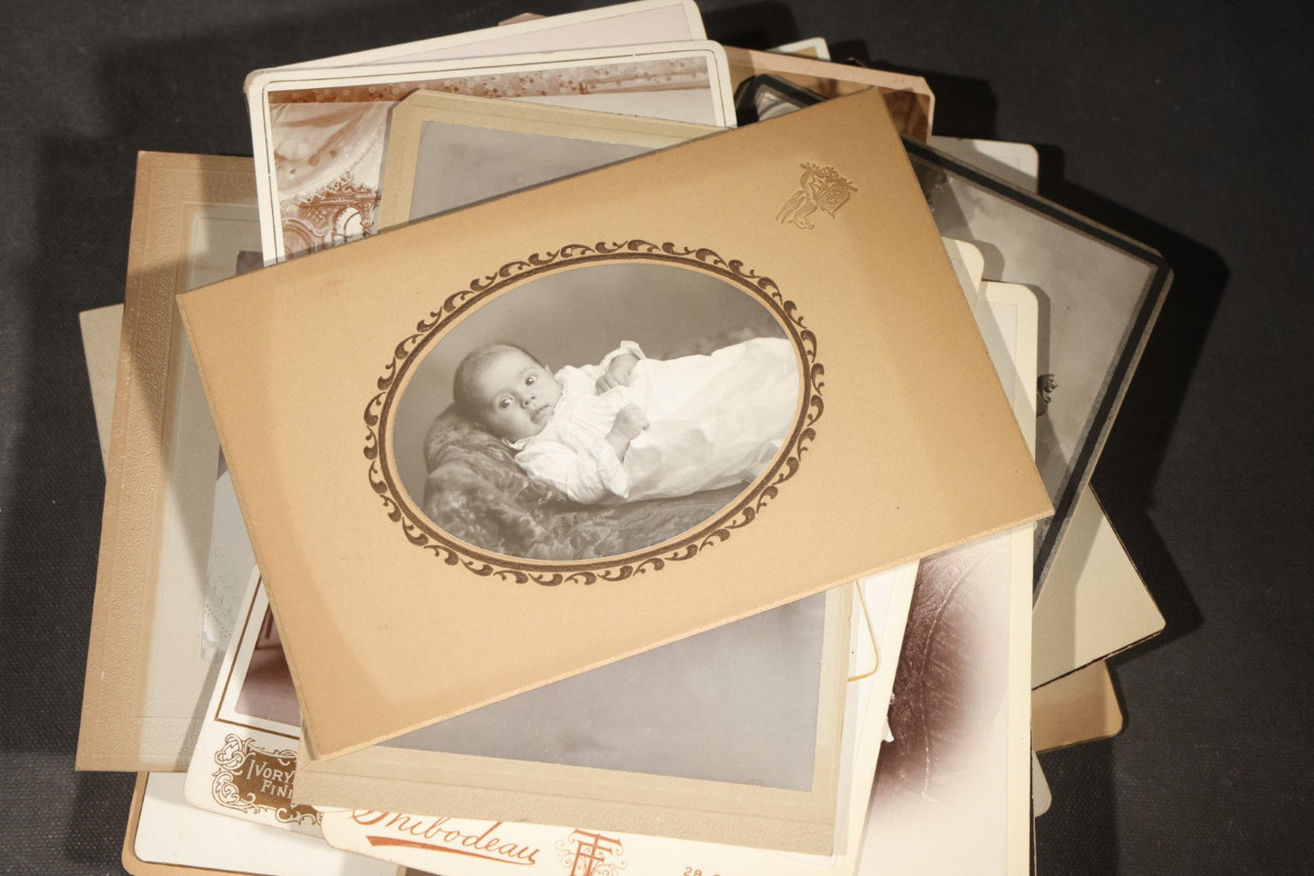 Grouping of 35+ Antique Cabinet Card and Board-Mounted Photographs including Schoolroom Interior and Posed Couple in Fur Coats
