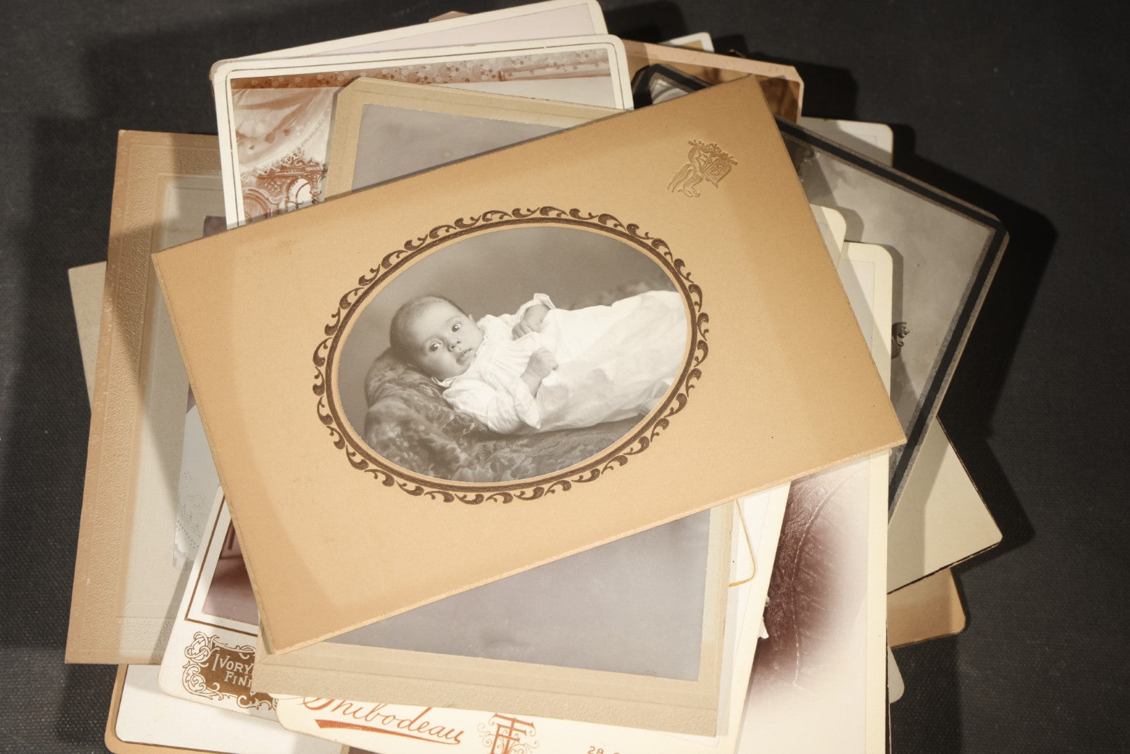 Grouping of 35+ Antique Cabinet Card and Board-Mounted Photographs including Schoolroom Interior and Posed Couple in Fur Coats