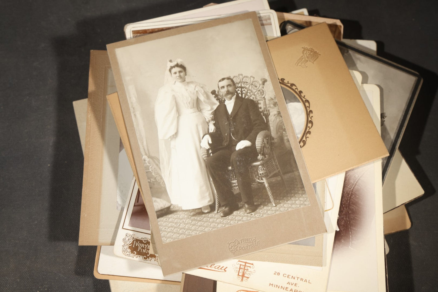 Grouping of 35+ Antique Cabinet Card and Board-Mounted Photographs including Schoolroom Interior and Posed Couple in Fur Coats