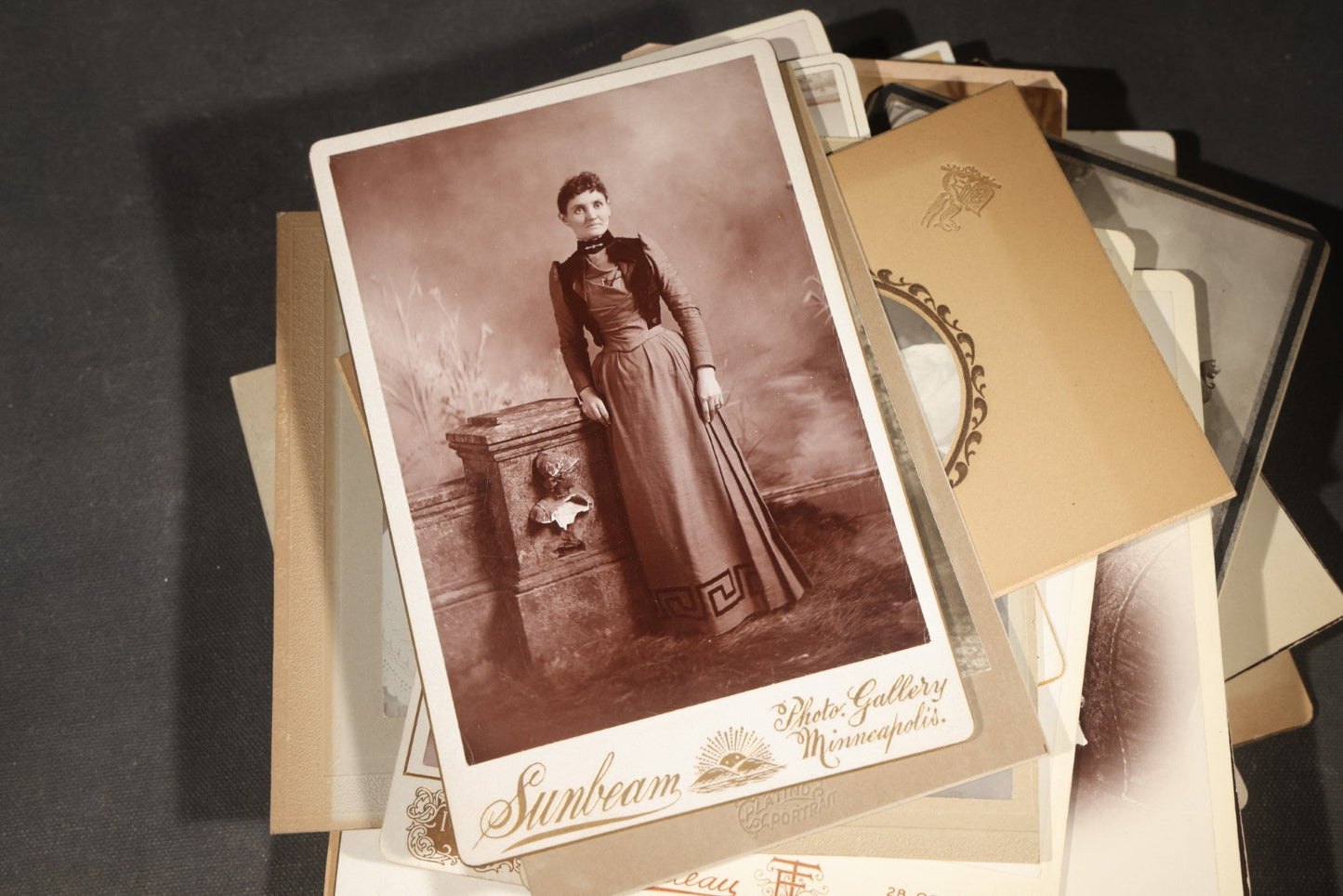 Grouping of 35+ Antique Cabinet Card and Board-Mounted Photographs including Schoolroom Interior and Posed Couple in Fur Coats
