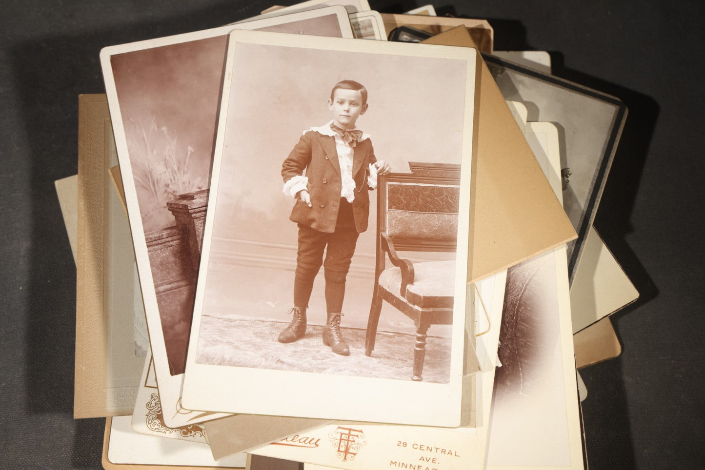 Grouping of 35+ Antique Cabinet Card and Board-Mounted Photographs including Schoolroom Interior and Posed Couple in Fur Coats