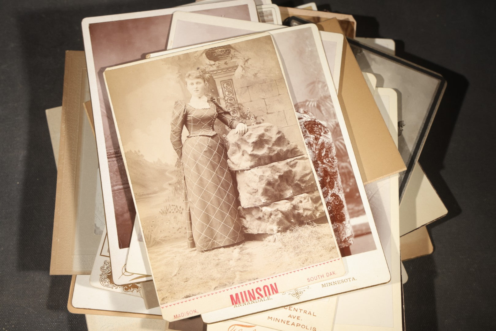 Grouping of 35+ Antique Cabinet Card and Board-Mounted Photographs including Schoolroom Interior and Posed Couple in Fur Coats