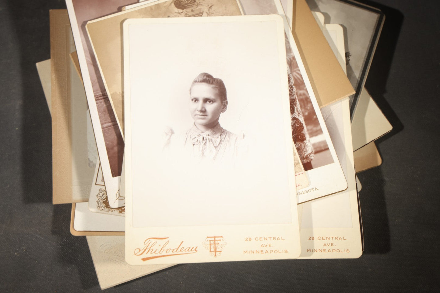 Grouping of 35+ Antique Cabinet Card and Board-Mounted Photographs including Schoolroom Interior and Posed Couple in Fur Coats