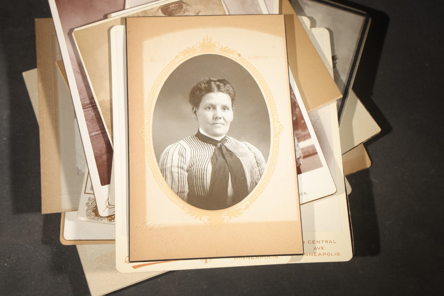 Grouping of 35+ Antique Cabinet Card and Board-Mounted Photographs including Schoolroom Interior and Posed Couple in Fur Coats