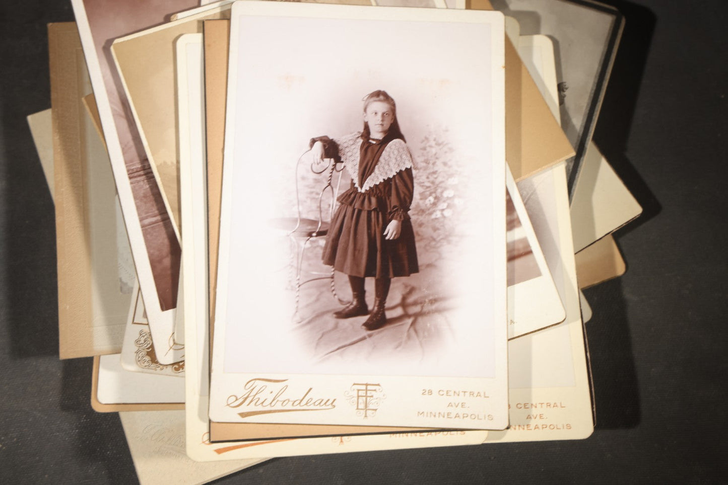 Grouping of 35+ Antique Cabinet Card and Board-Mounted Photographs including Schoolroom Interior and Posed Couple in Fur Coats