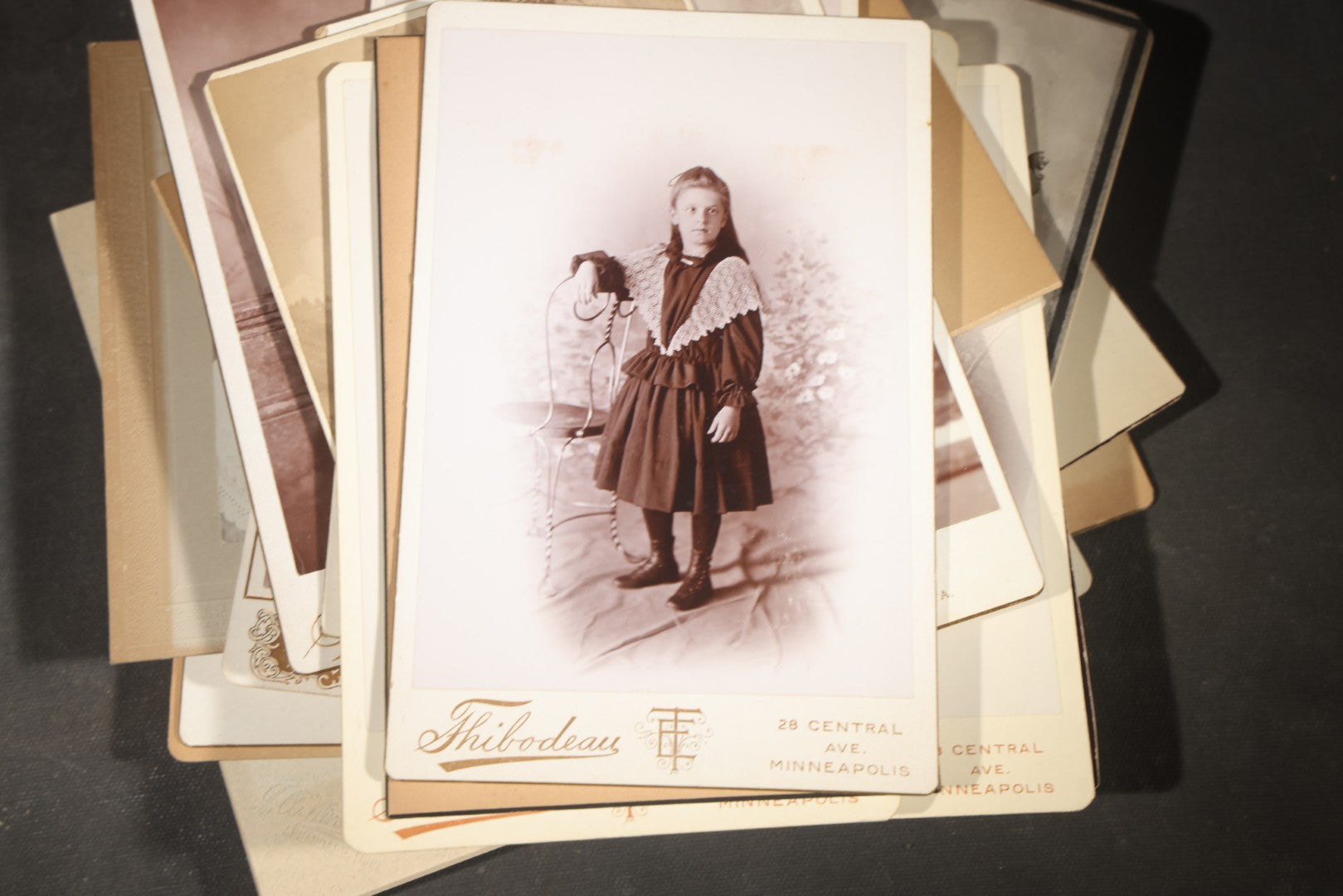 Grouping of 35+ Antique Cabinet Card and Board-Mounted Photographs including Schoolroom Interior and Posed Couple in Fur Coats