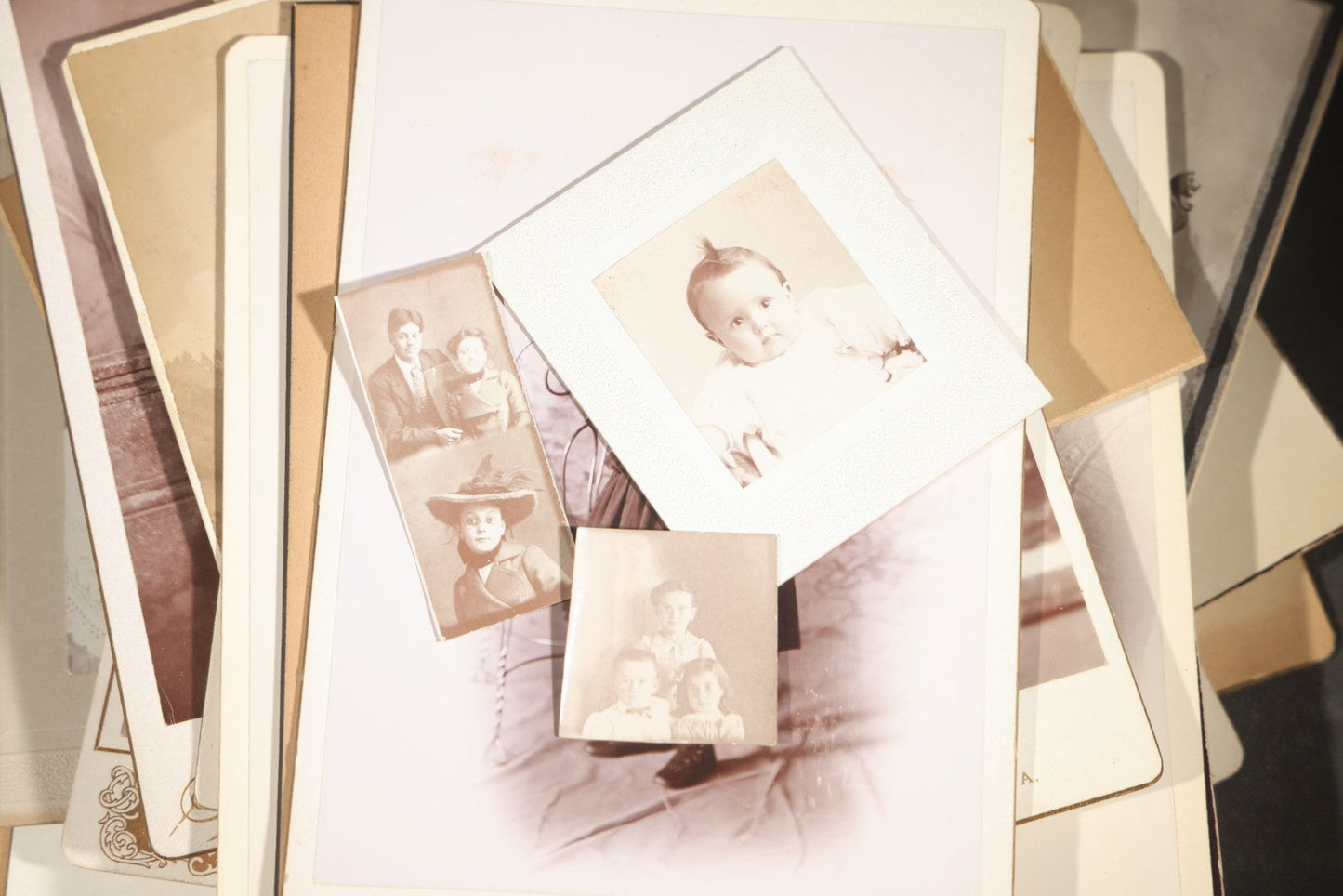 Grouping of 35+ Antique Cabinet Card and Board-Mounted Photographs including Schoolroom Interior and Posed Couple in Fur Coats