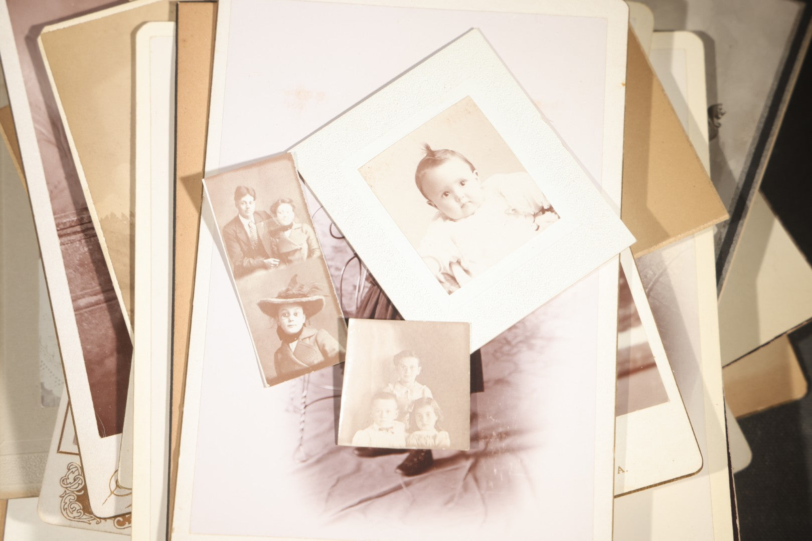 Grouping of 35+ Antique Cabinet Card and Board-Mounted Photographs including Schoolroom Interior and Posed Couple in Fur Coats