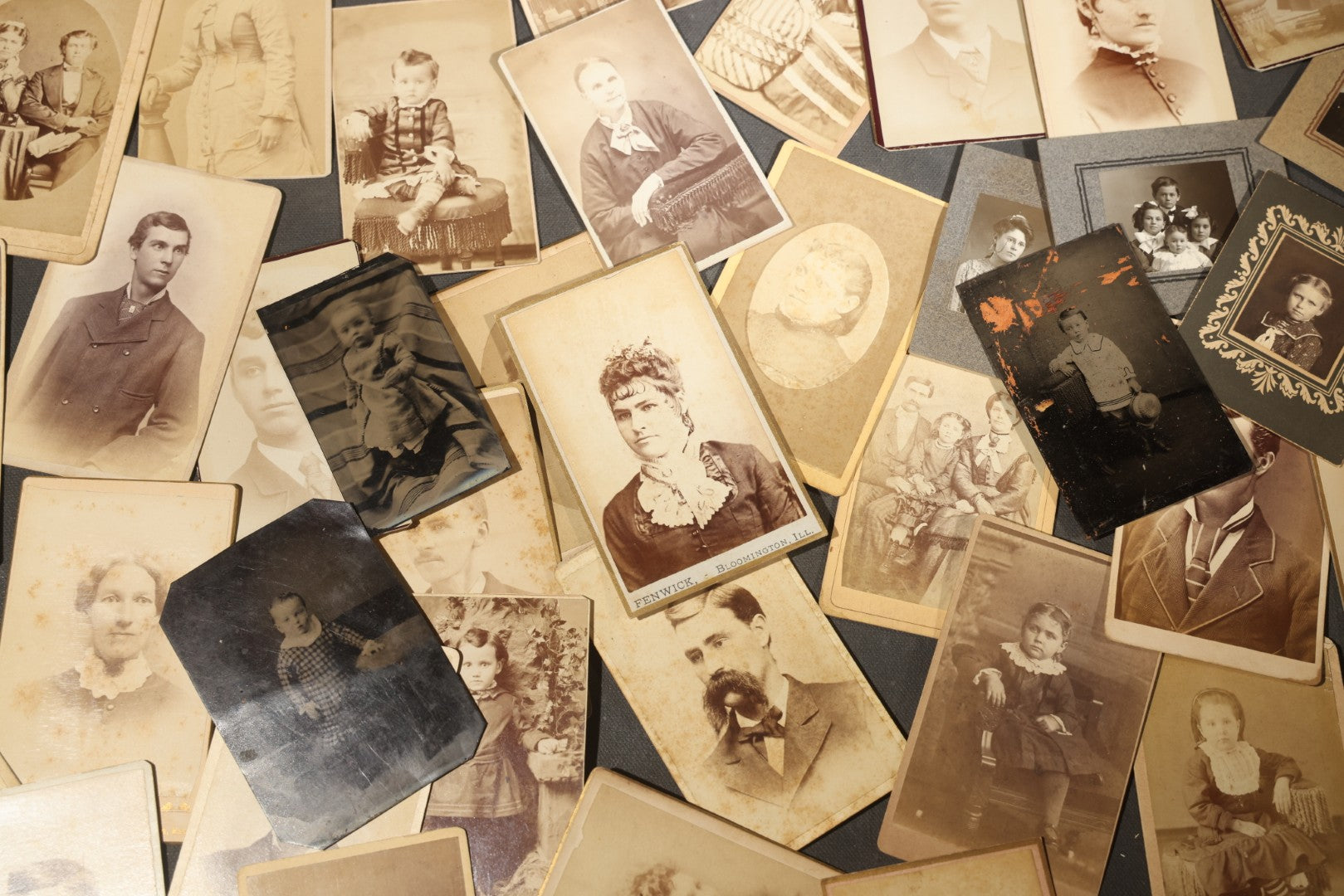 Grouping of 40+ Antique Photographs Including Carte De Visite C.D.V. Portraits, Tintype Photographs, and Board-Mounted Photographs, including young children, women with curled bangs, and more