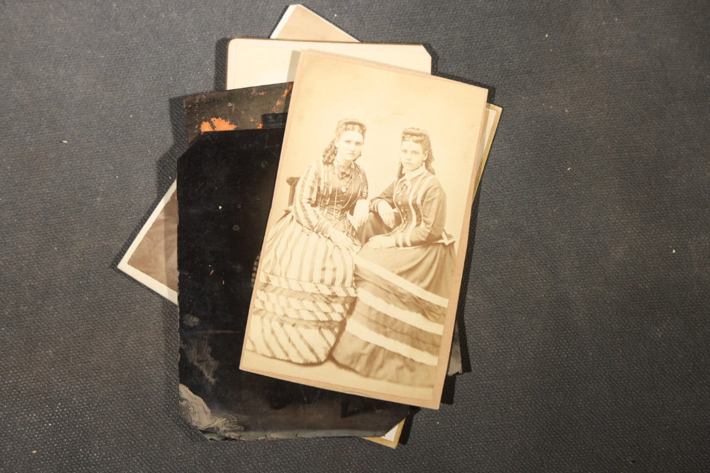 Grouping of 40+ Antique Photographs Including Carte De Visite C.D.V. Portraits, Tintype Photographs, and Board-Mounted Photographs, including young children, women with curled bangs, and more
