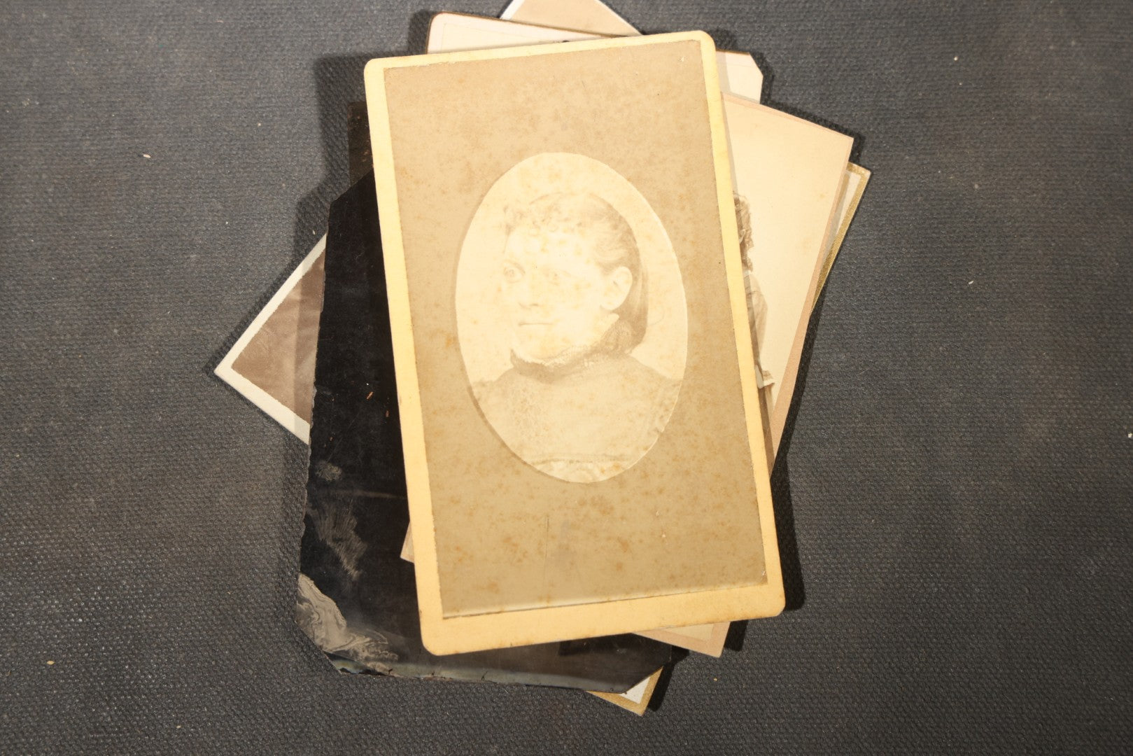 Grouping of 40+ Antique Photographs Including Carte De Visite C.D.V. Portraits, Tintype Photographs, and Board-Mounted Photographs, including young children, women with curled bangs, and more