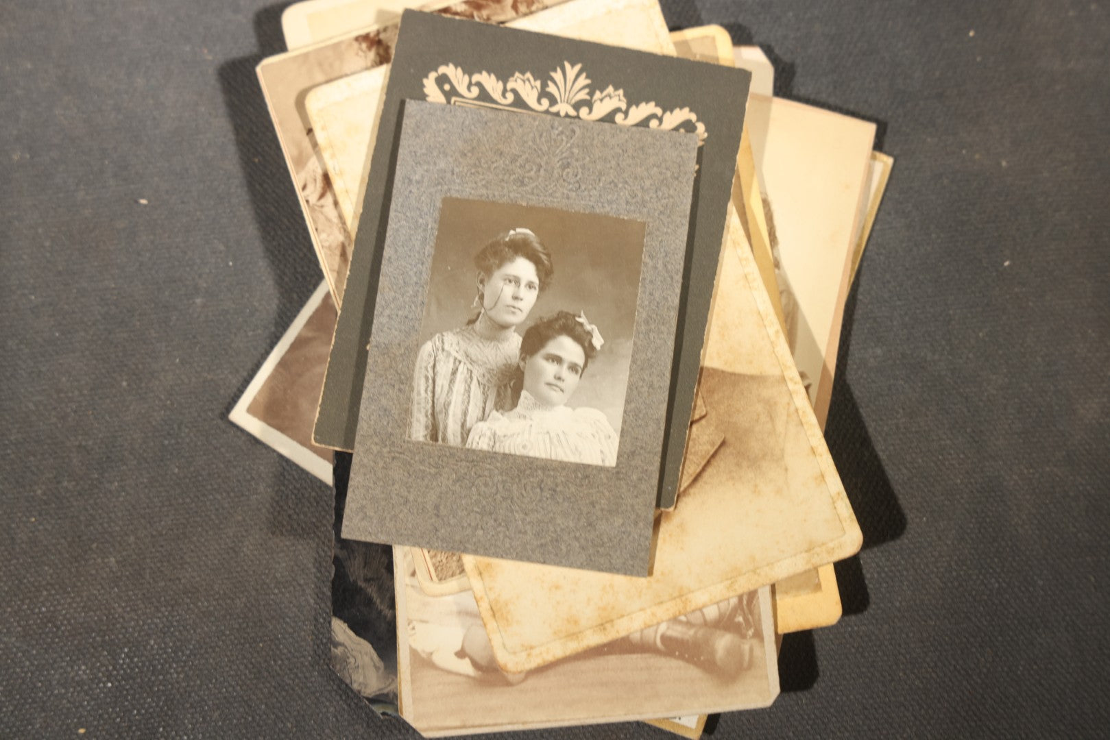 Grouping of 40+ Antique Photographs Including Carte De Visite C.D.V. Portraits, Tintype Photographs, and Board-Mounted Photographs, including young children, women with curled bangs, and more