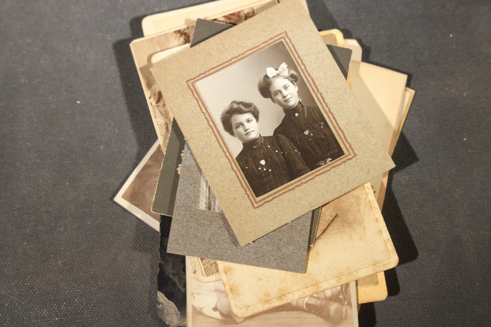 Grouping of 40+ Antique Photographs Including Carte De Visite C.D.V. Portraits, Tintype Photographs, and Board-Mounted Photographs, including young children, women with curled bangs, and more